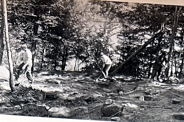 The only photograph we know of from the hand-clearing of the site in the 1960s. We think one of the men is Fred Logan Bull — the print is to…